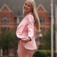 Female student in suit walking outside